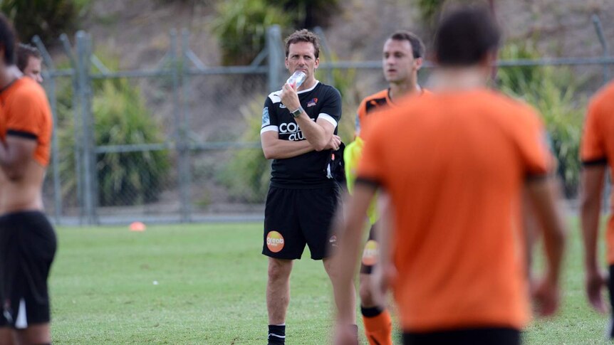 Brisbane Roar's new coach Mike Mulvey (centre) looks on during training.