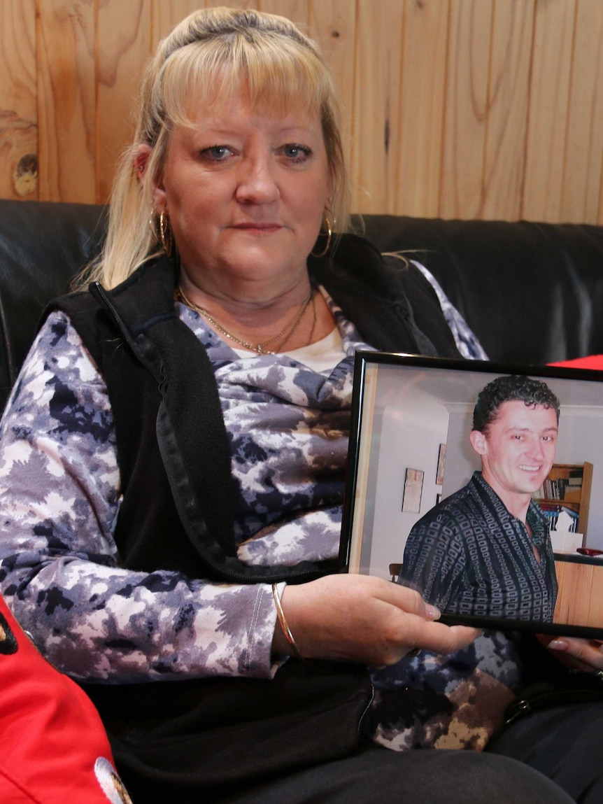 Shani Clarke holds photo of her son Mick