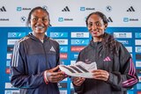 Sheila Chepkirui and Tigist Assefa hold an adidas shoe