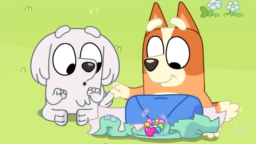 Two cartoon dogs play pass-the-parcel in an episode of Bluey.