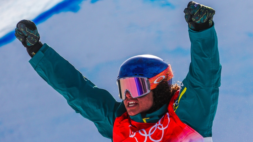 Valentino Guseli holds his hands above his head and clenches his teeth after a run