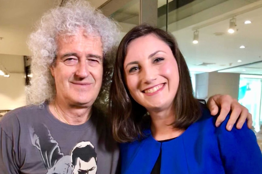 Queen guitarist Brian May with ABC reporter Candice Prosser.