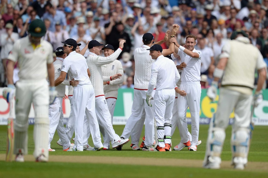 Stuart Broad celebrates with team-mates after dismissing Shaun Marsh on day one at Trent Bridge.