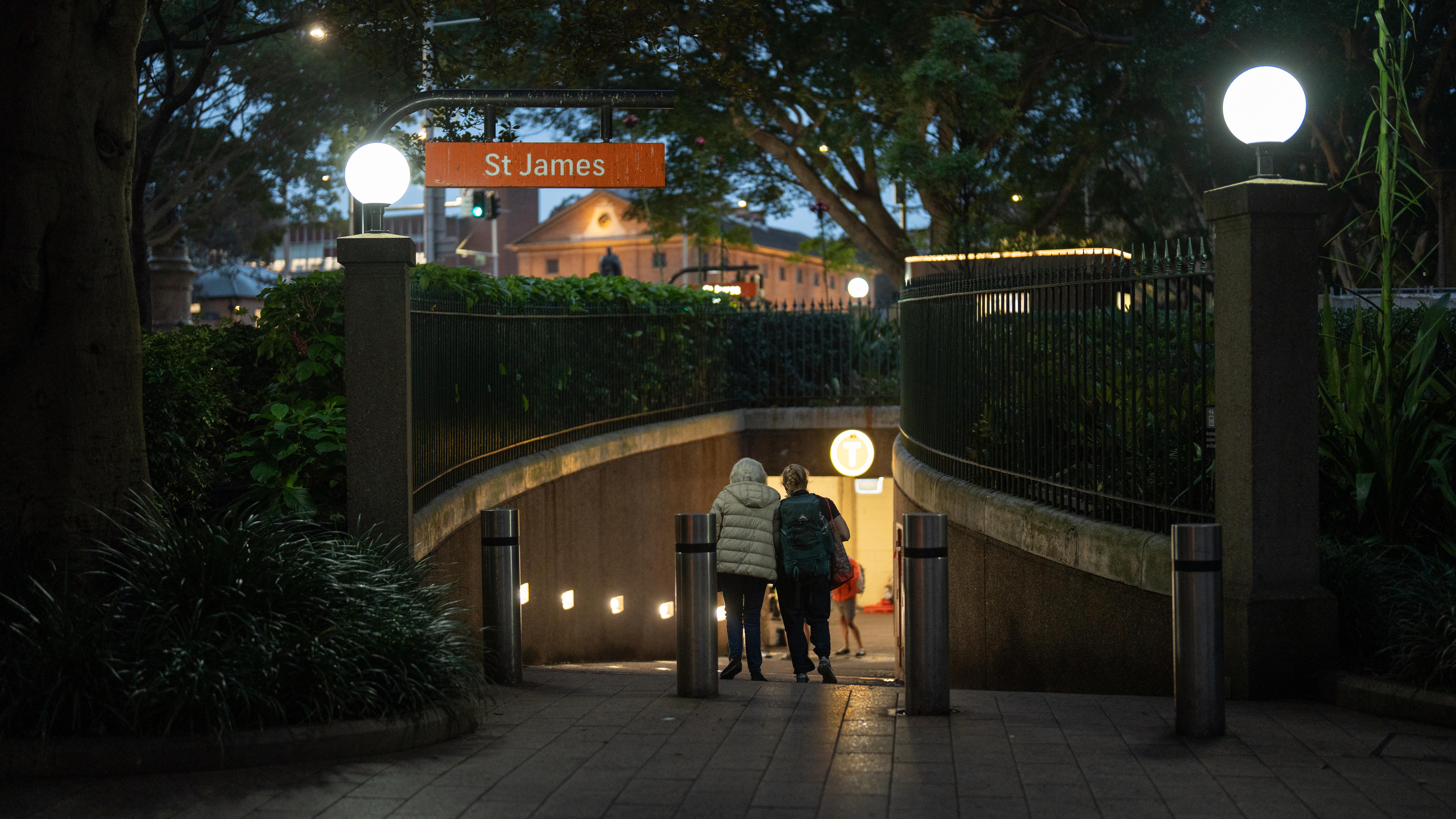 Commuters walk into the entrance of St James train station.