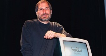 Steve Jobs leans on a new iMac computer with his elbow in 1998.