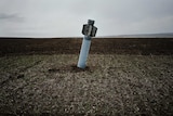 An unexploded rocket in field near the village of Dmitrivka.