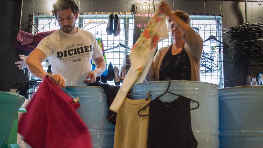 Michael Stafford and his mum Helen sort clothes in the store.