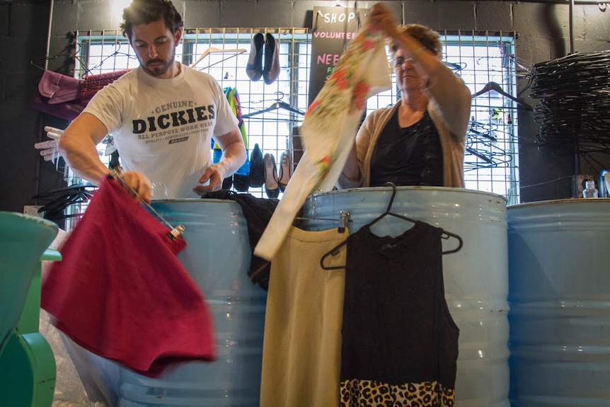 Michael Stafford and his mum Helen sort clothes in the store.