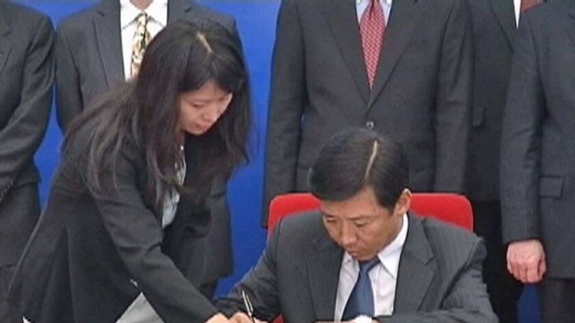 Landmark deal: The agreement was signed in Beijing last night.