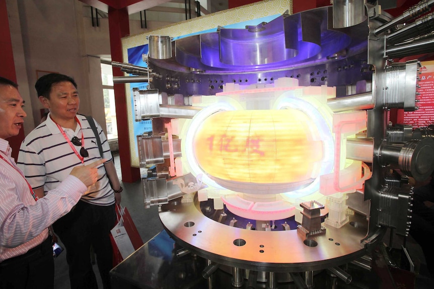 People look at a model of ITER