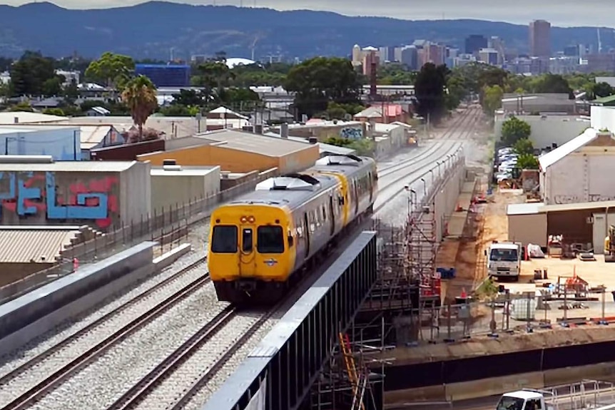 Adelaide train crosses new rail overpass at South Road