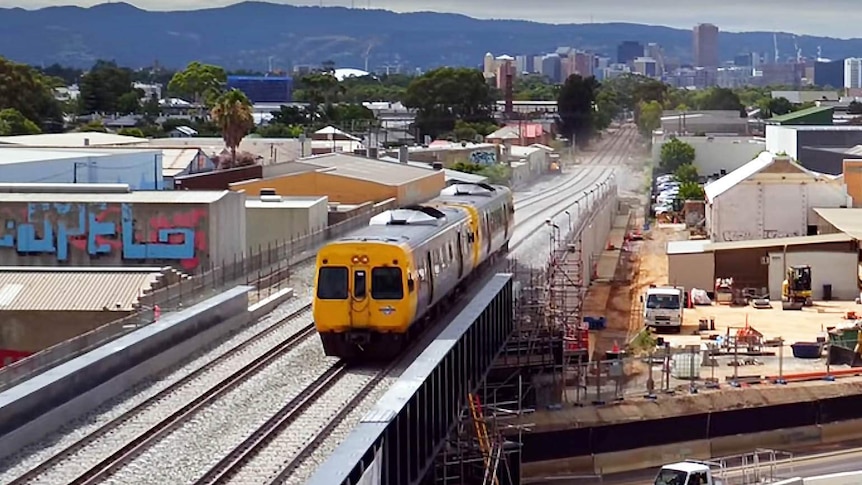 Adelaide train crosses new rail overpass at South Road