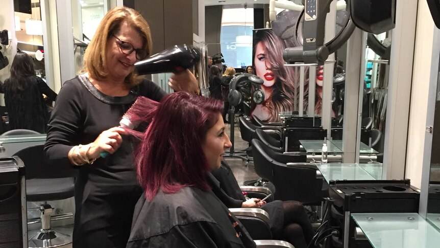 A photograph of hairdresser Debbie Cook at work