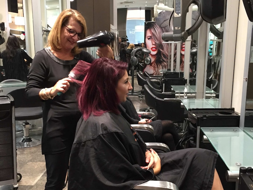 A photograph of hairdresser Debbie Cook at work