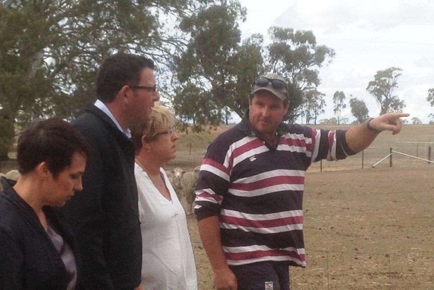 Three politicians are taken on a tour of a drought-affected farm by the land owner