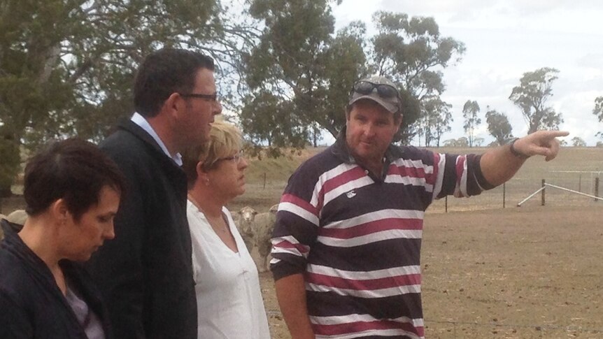 Three politicians are taken on a tour of a drought-affected farm by the land owner