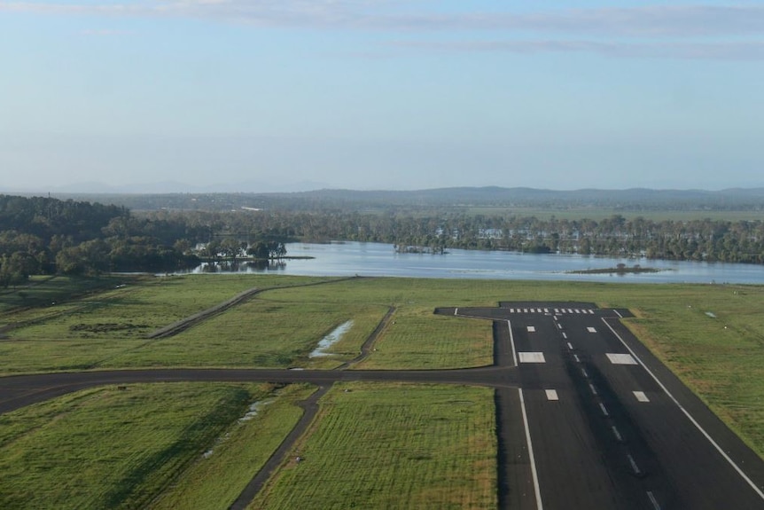 An aerial shot of floodwaters creeping closer to the Rockhampton Airport runway on Sunday morning