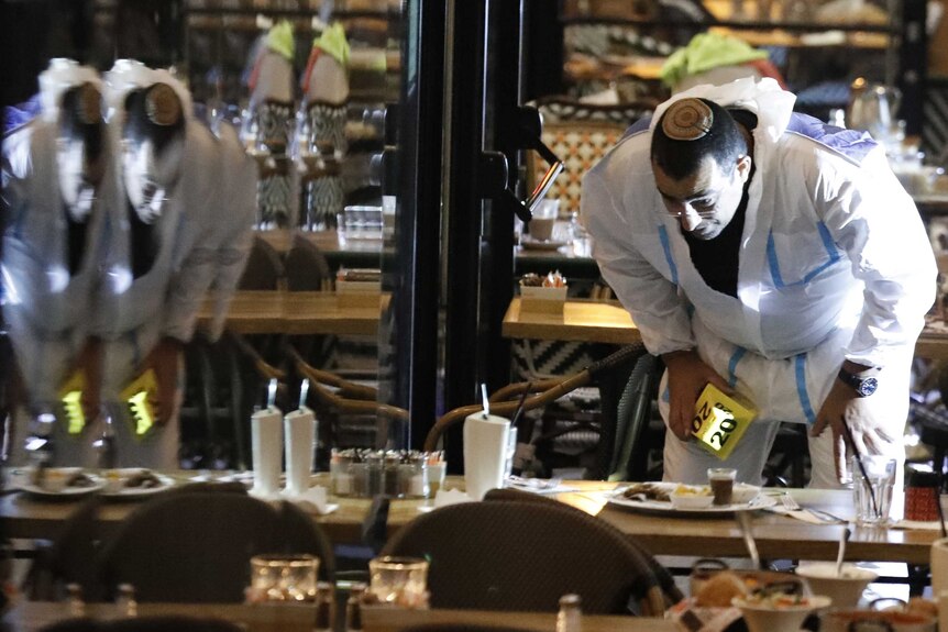 Forensic police inspecting a restaurant after a shooting in Tel Aviv