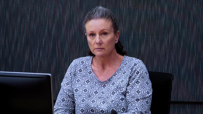 A woman sits at a desk