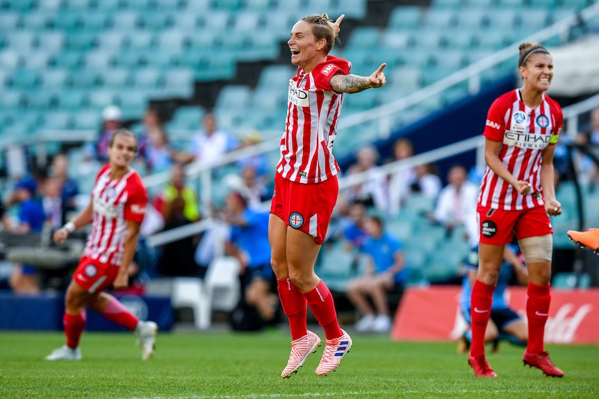 Jess Fishlock jumps in the air after the full-time whistle in Melbourne City's W-League grand final win.
