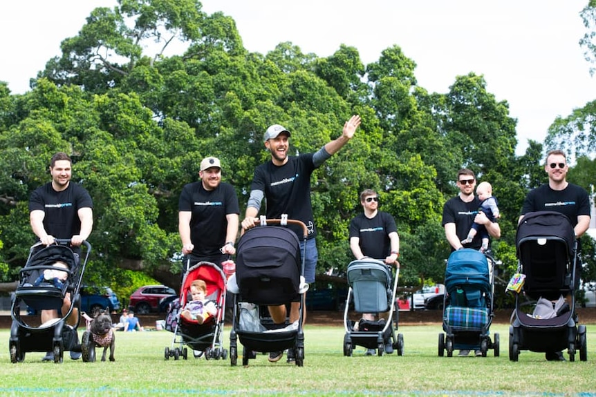 A group of Dads pushing prams 