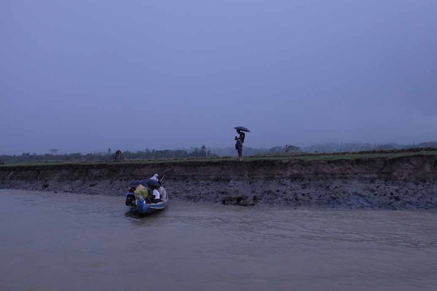 Muslim villagers boarding a small boat.