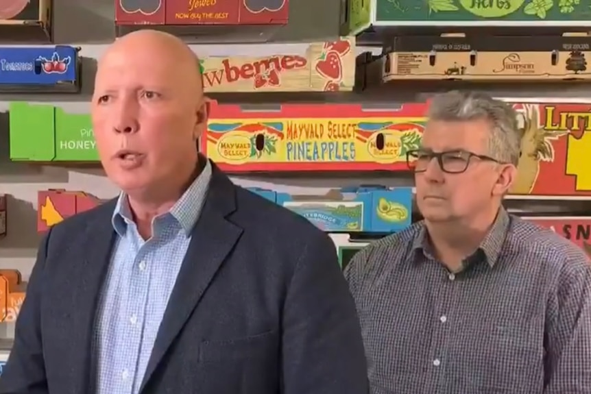 Mid shot of Peter Dutton and Keith Pitt in front of empty fruit boxes