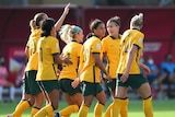 Australia soccer players walk in a group after scoring a goal in the Asian Cup