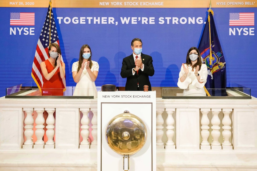 New York State Governor Andrew Cuomo claps after ringing the opening bell.
