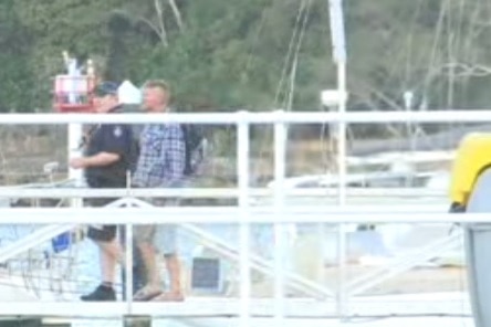 The man believed to have been reported missing returned to shore safely, escorted by a police officer.
