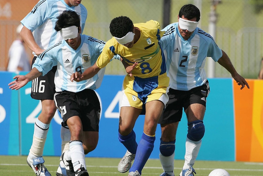 Brazil's Severino Silva (C) gets tackled by Argentina players in football five-a-side in London.