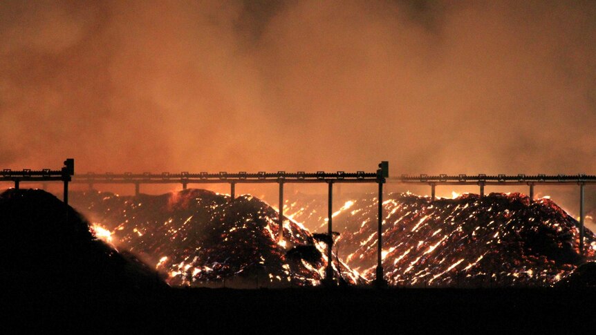Fire burns in almond husks at the Olam processing facility near Mildura.
