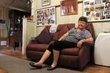 Kath Swift sits on the couch at her home in Mount Isa, north west Queensland.