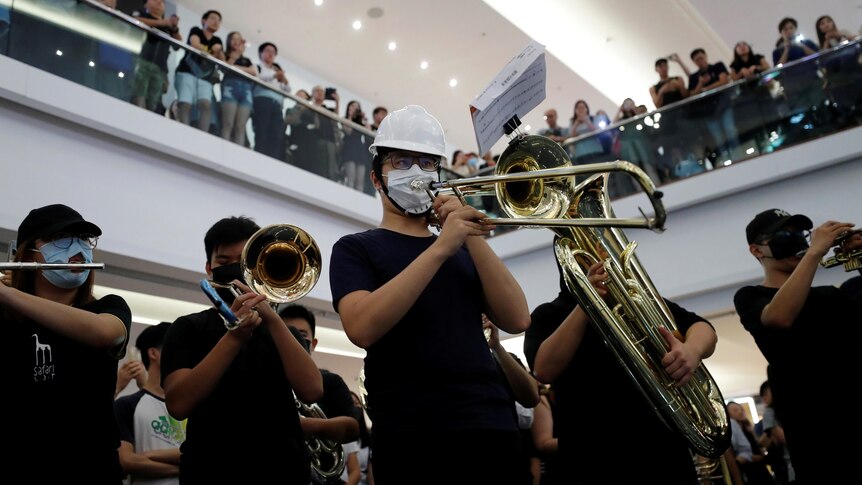 A brass band plays during a flash mob in a shopping mall. 