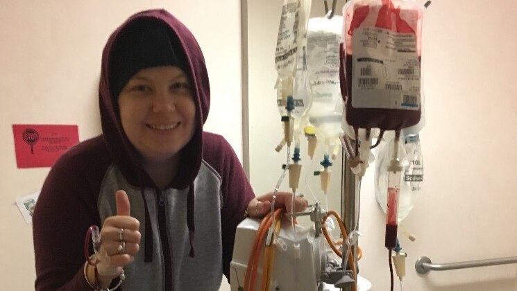 Michelle Climpson wears a hoodie in a hospital room.