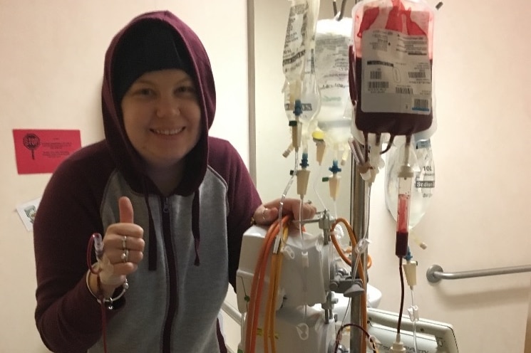 Michelle Climpson wears a hoodie in a hospital room.