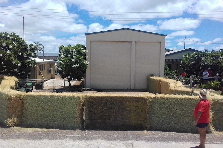 Hay bales used to keep a large crocodile at bay