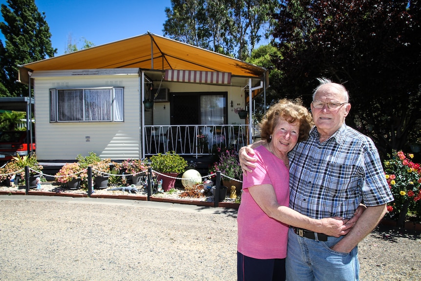 Jim and Denise Merriner standing outside their home.
