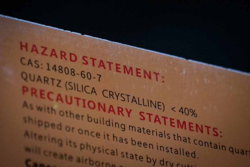 Text on a sheet of engineered stone says Hazard Statement, Precautionary statement.