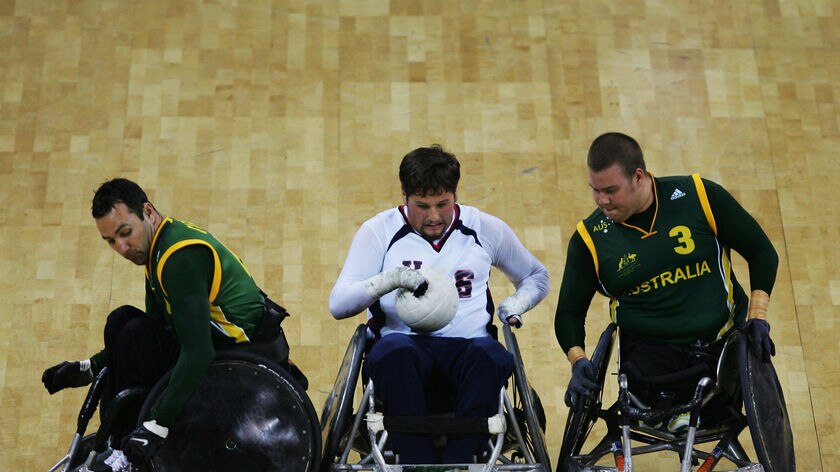 The United States' Norm Lyduch (C) is tackled by Australia's Cameron Carr (L) and Ryley Batt (R)