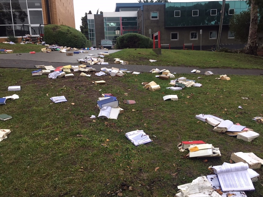 Books from the University of Tasmania washed out of the Law Library and across the lawns
