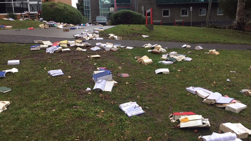 Books from the University of Tasmania washed out of the Law Library and across the lawns