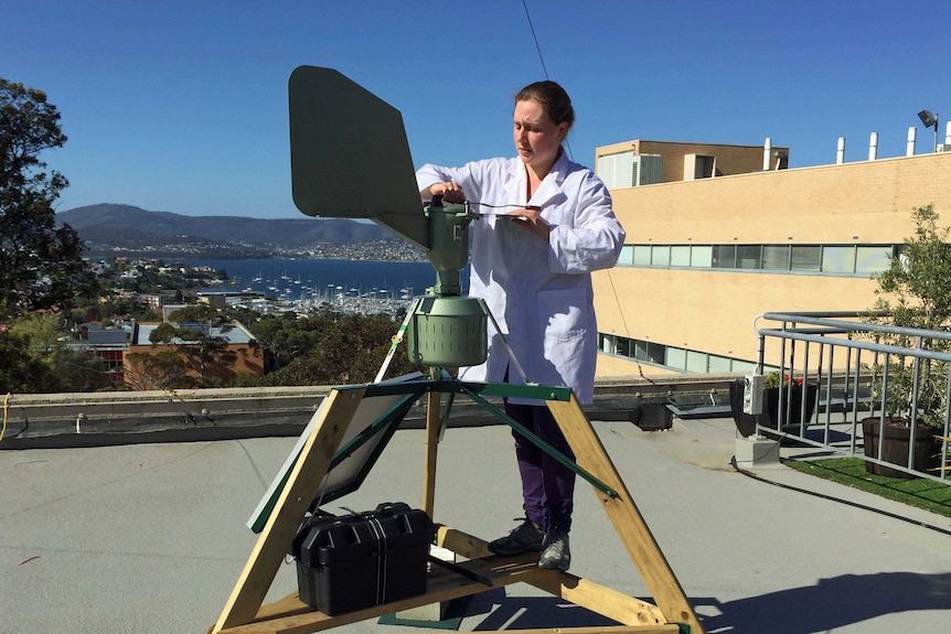 Student Laura Van Galen checks an air monitor