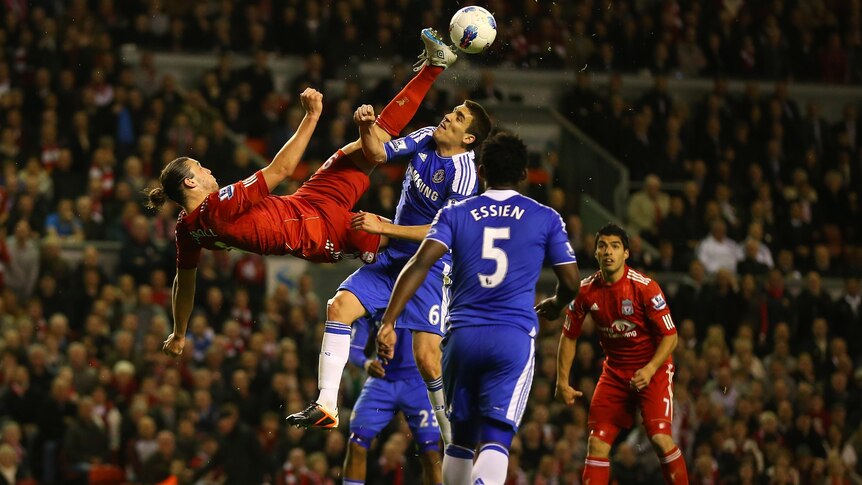 Andy Carroll attempts an audacious bicycle kick in the Anfield rout.