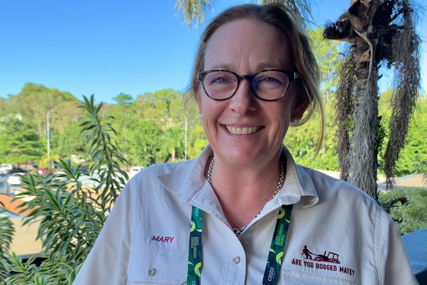 woman in cream work shirt at conference