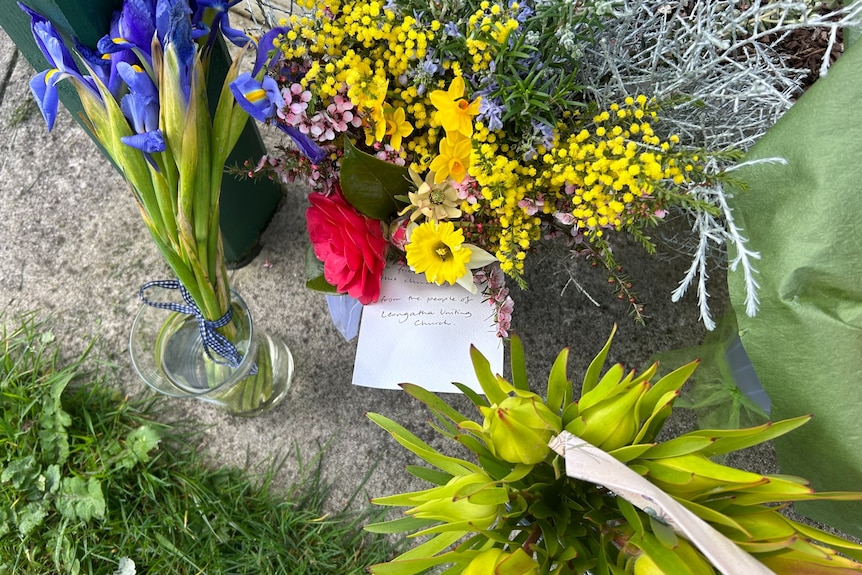 Flowers and a note on the ground.
