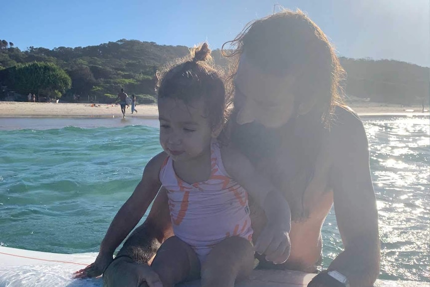 Joel and his daughter at the beach in Byron Bay