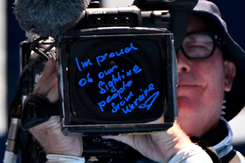 A message is seen written on a TV camera at the 2024 Australian Open.
