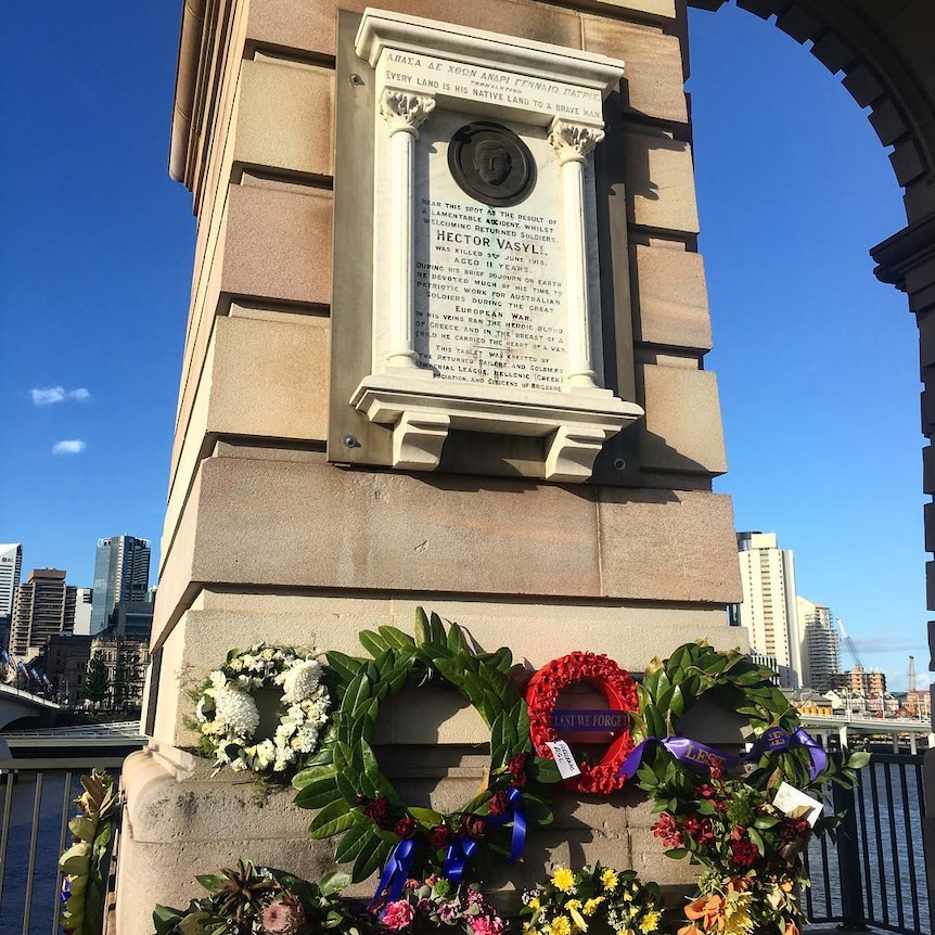 Stone memorial with flowers around it