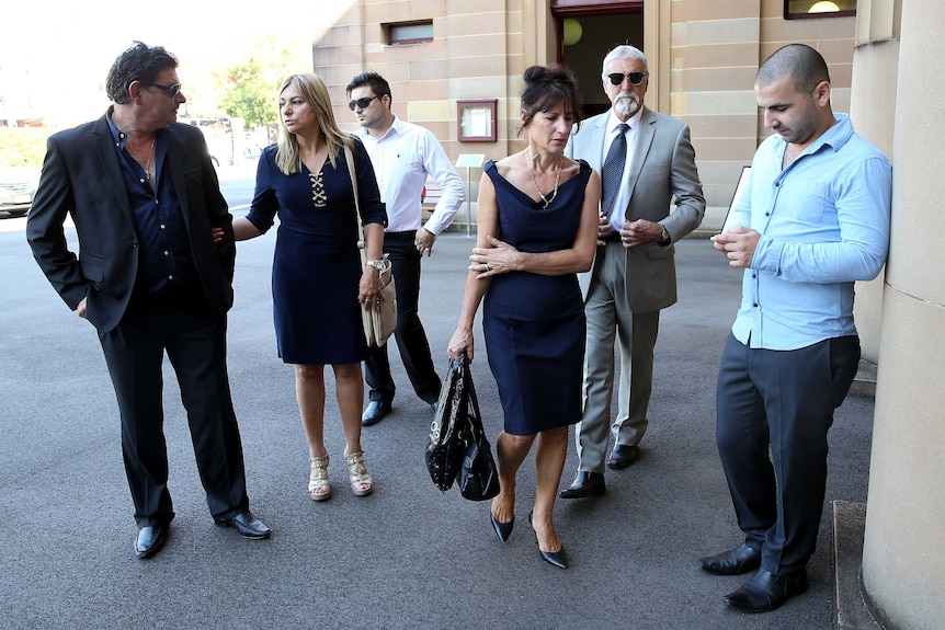 Family members of Nicholas Lambaditis, on trial for the murder of Brazilian Lucio Stein Rodrigues, wait outside court in Sydney.